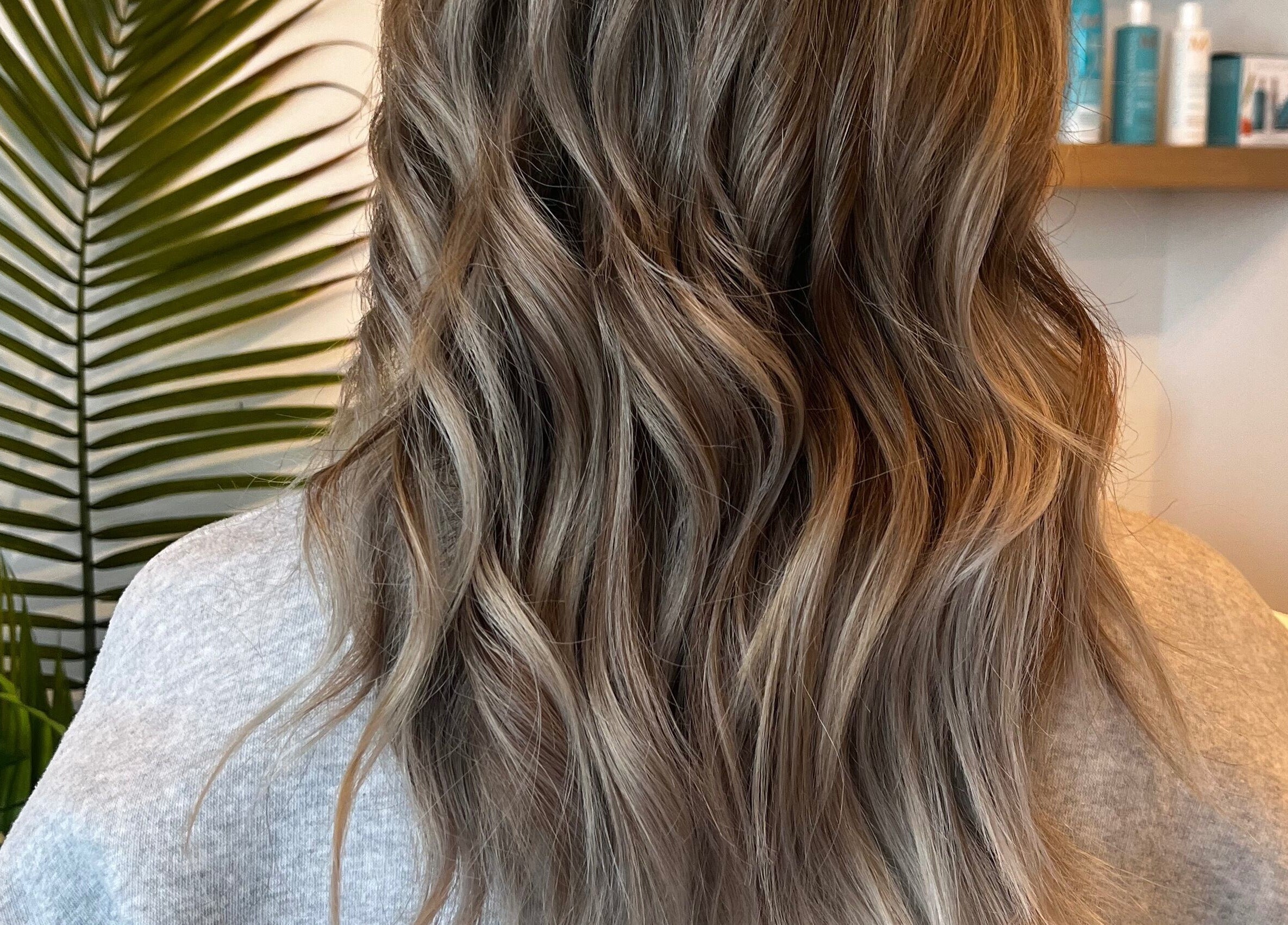 Elegant wavy hairstyle at Hair By Jordyn, Windsor, Ontario, CA, showcasing seamless highlights.