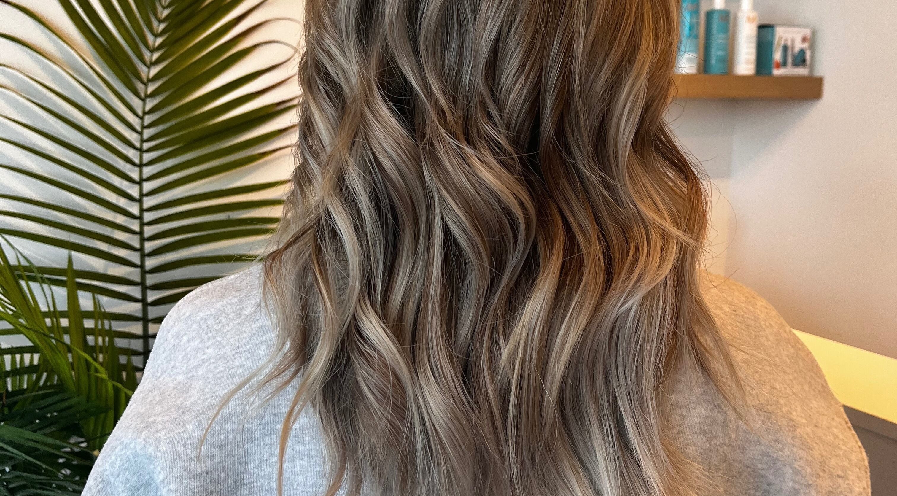 Elegant wavy hairstyle at Hair By Jordyn, Windsor, Ontario, CA, showcasing seamless highlights.