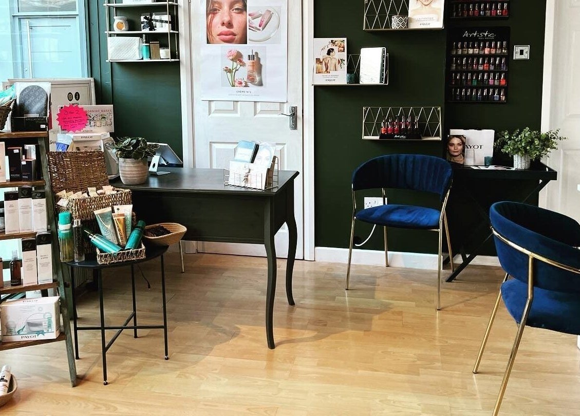 Inside Queens Parlour, Macclesfield, England, GB, showcasing product displays and sleek seating.