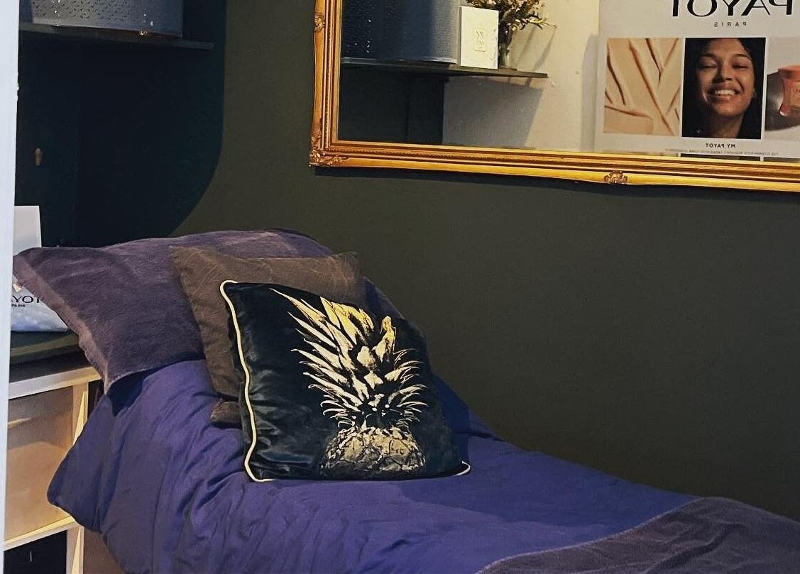 Cozy treatment room at Queens Parlour, Macclesfield, England, GB, featuring plush bedding and elegant decor.