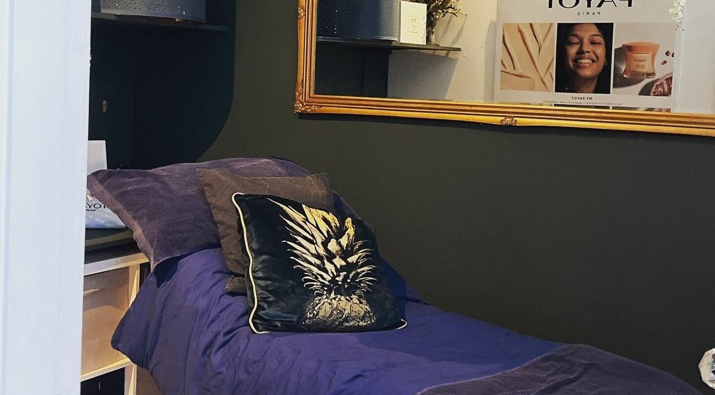 Cozy treatment room at Queens Parlour, Macclesfield, England, GB, featuring plush bedding and elegant decor.