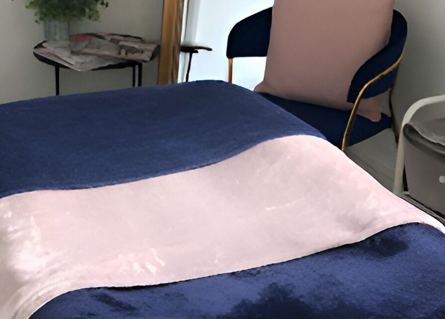 Luxurious treatment bed at Queens Parlour, Macclesfield, England, GB offering a serene relaxation experience.