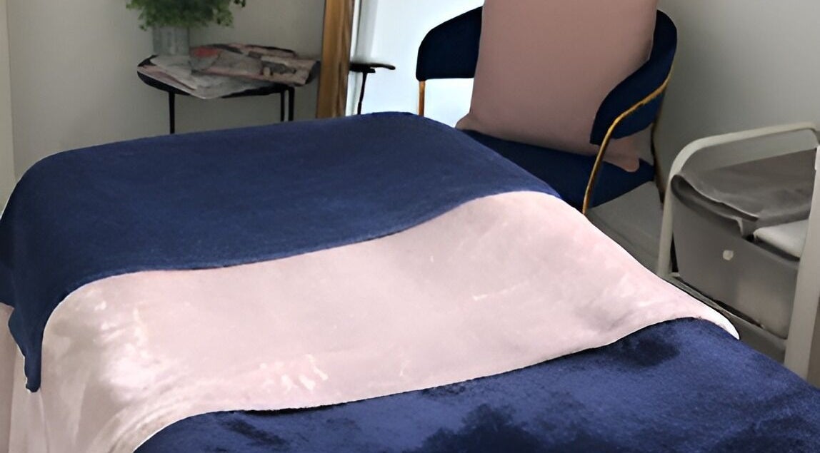 Luxurious treatment bed at Queens Parlour, Macclesfield, England, GB offering a serene relaxation experience.