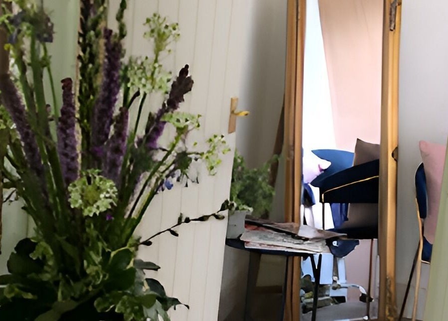 Chic floral arrangement beside a mirror at Queens Parlour, Macclesfield, England, GB creating a serene ambiance.