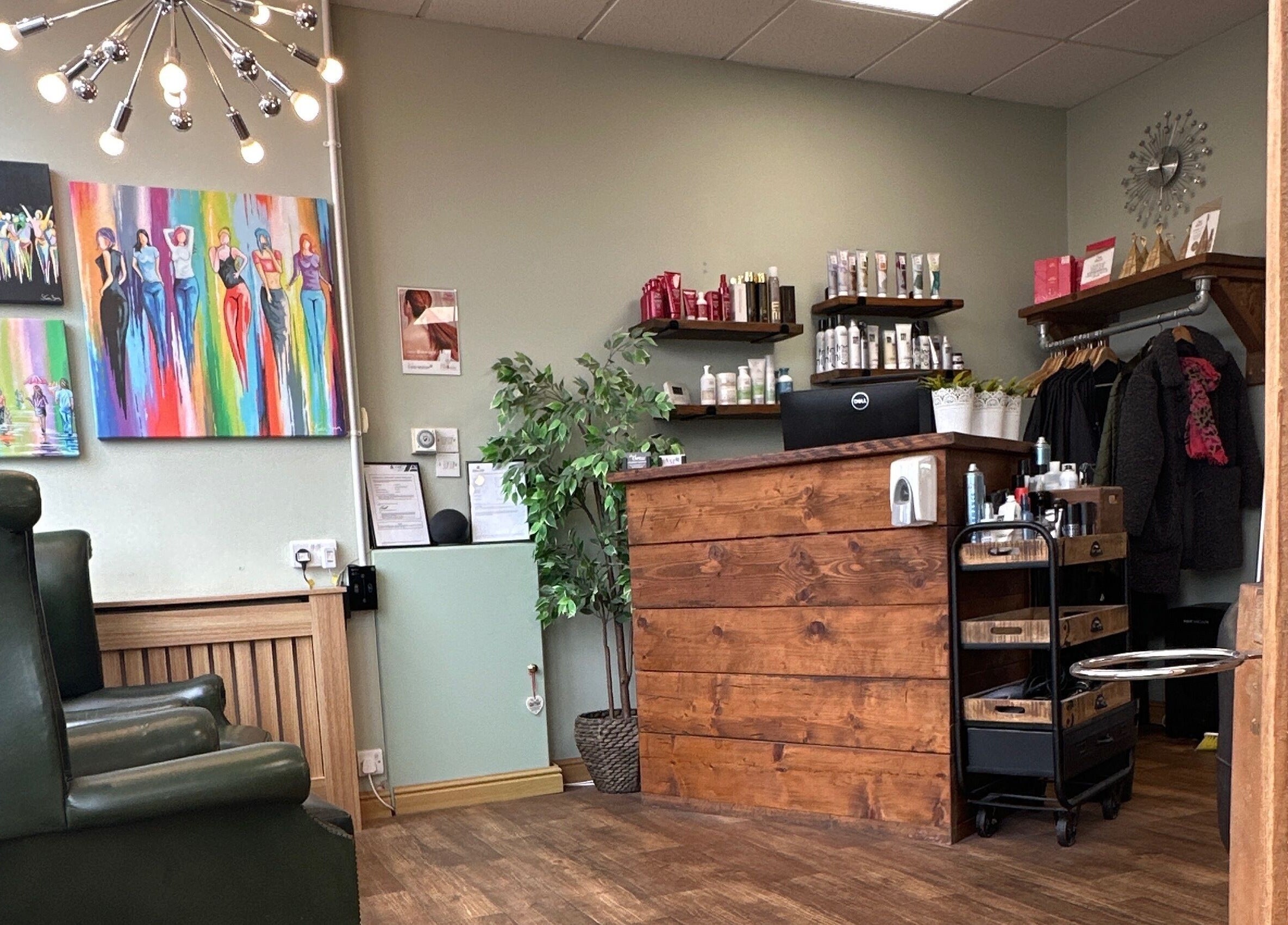 Stylish reception area at Moda Capelli, Ashington, England, GB, featuring modern art and elegant decor.