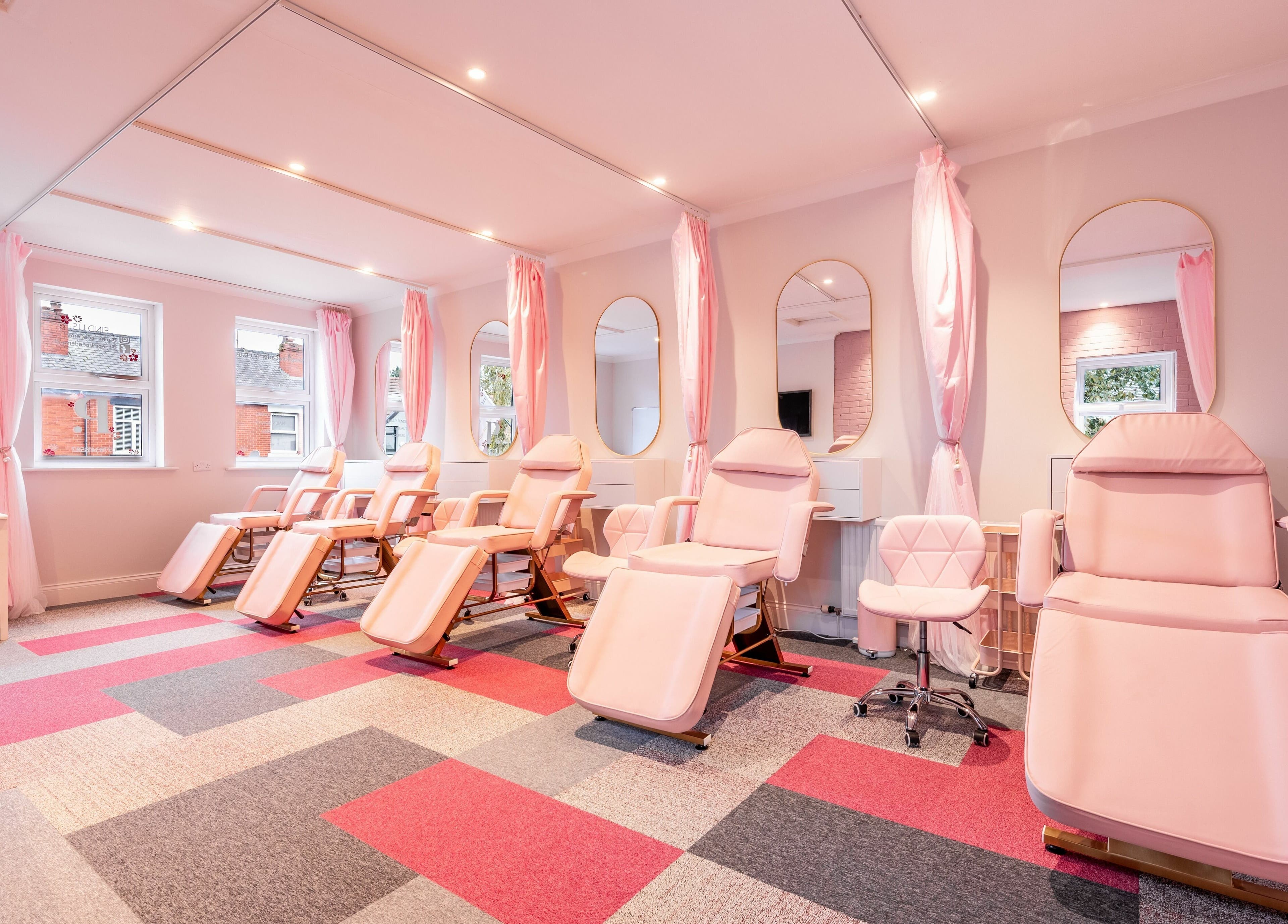 Elegant massage chairs and mirrors at Pink. Academy, Worsley, England, GB offer a serene beauty experience.