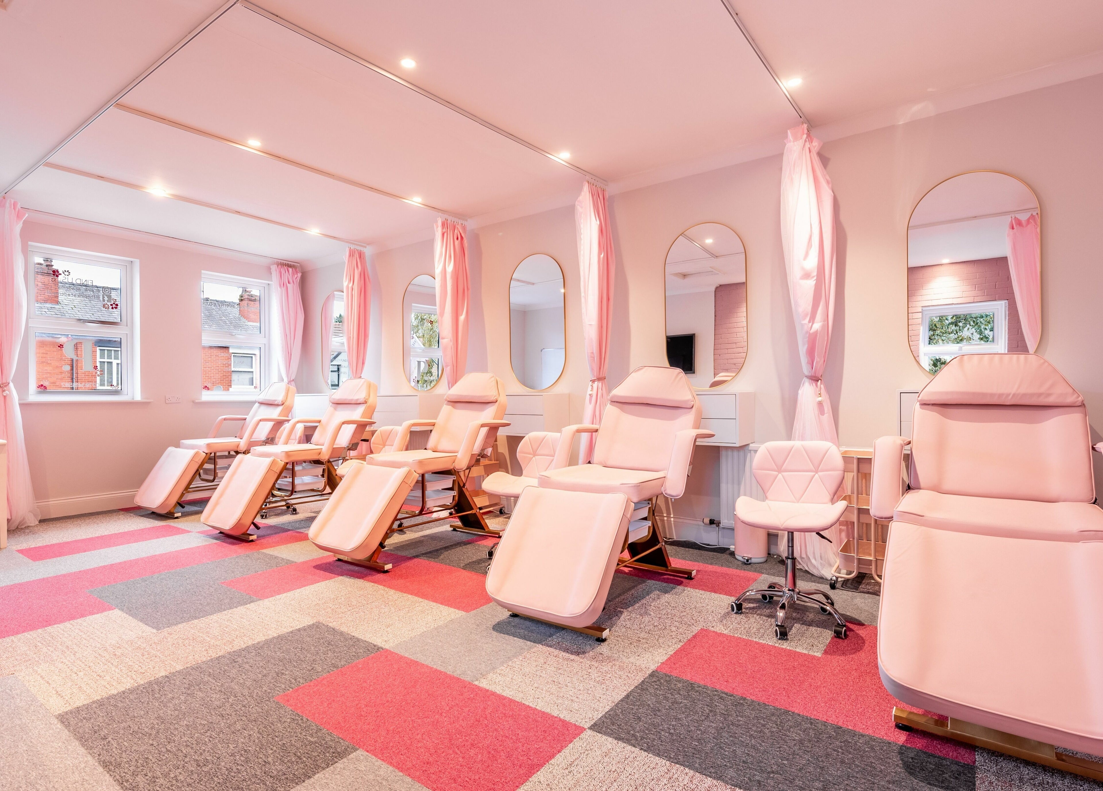 Elegant massage chairs and mirrors at Pink. Academy, Worsley, England, GB offer a serene beauty experience.