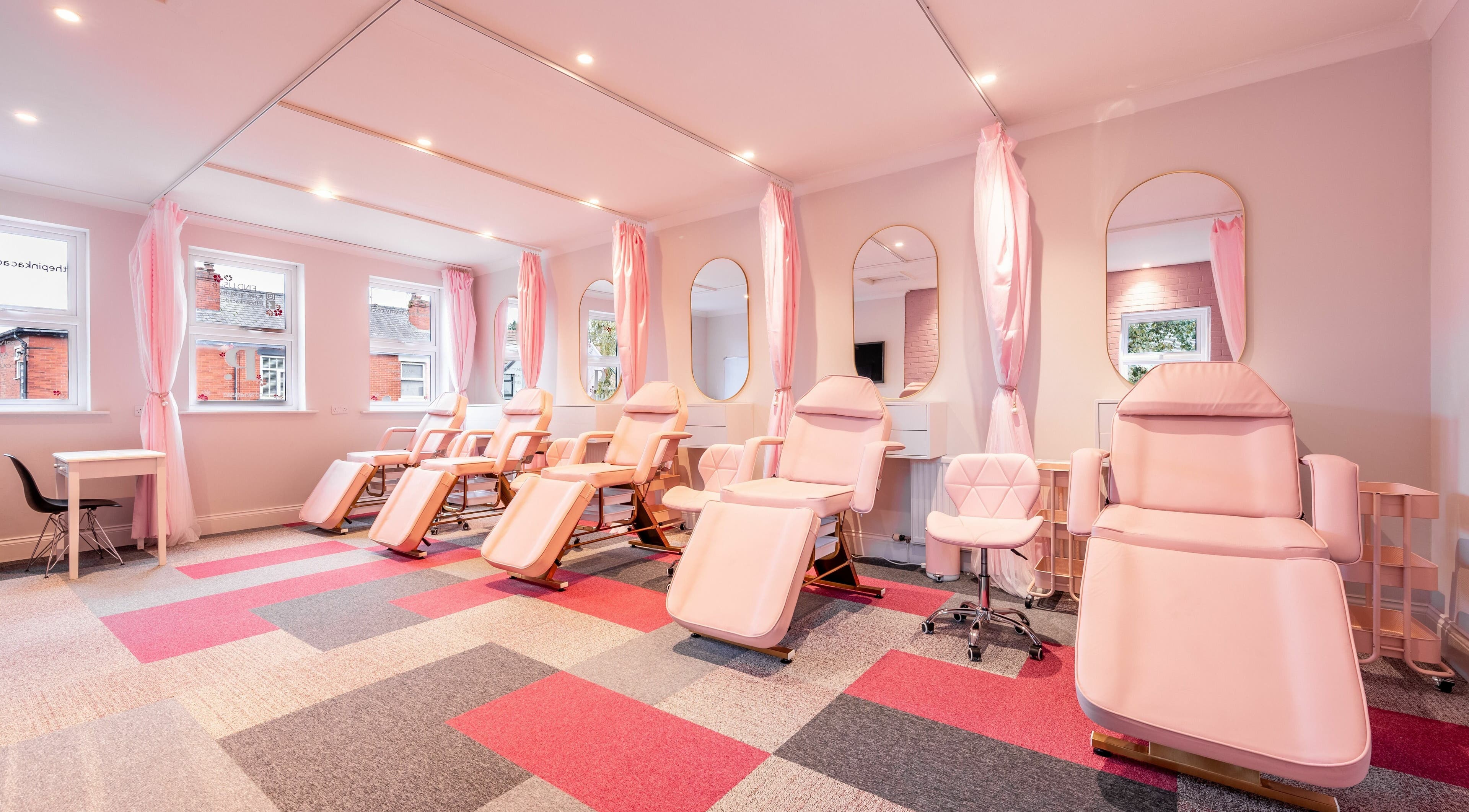 Elegant massage chairs and mirrors at Pink. Academy, Worsley, England, GB offer a serene beauty experience.