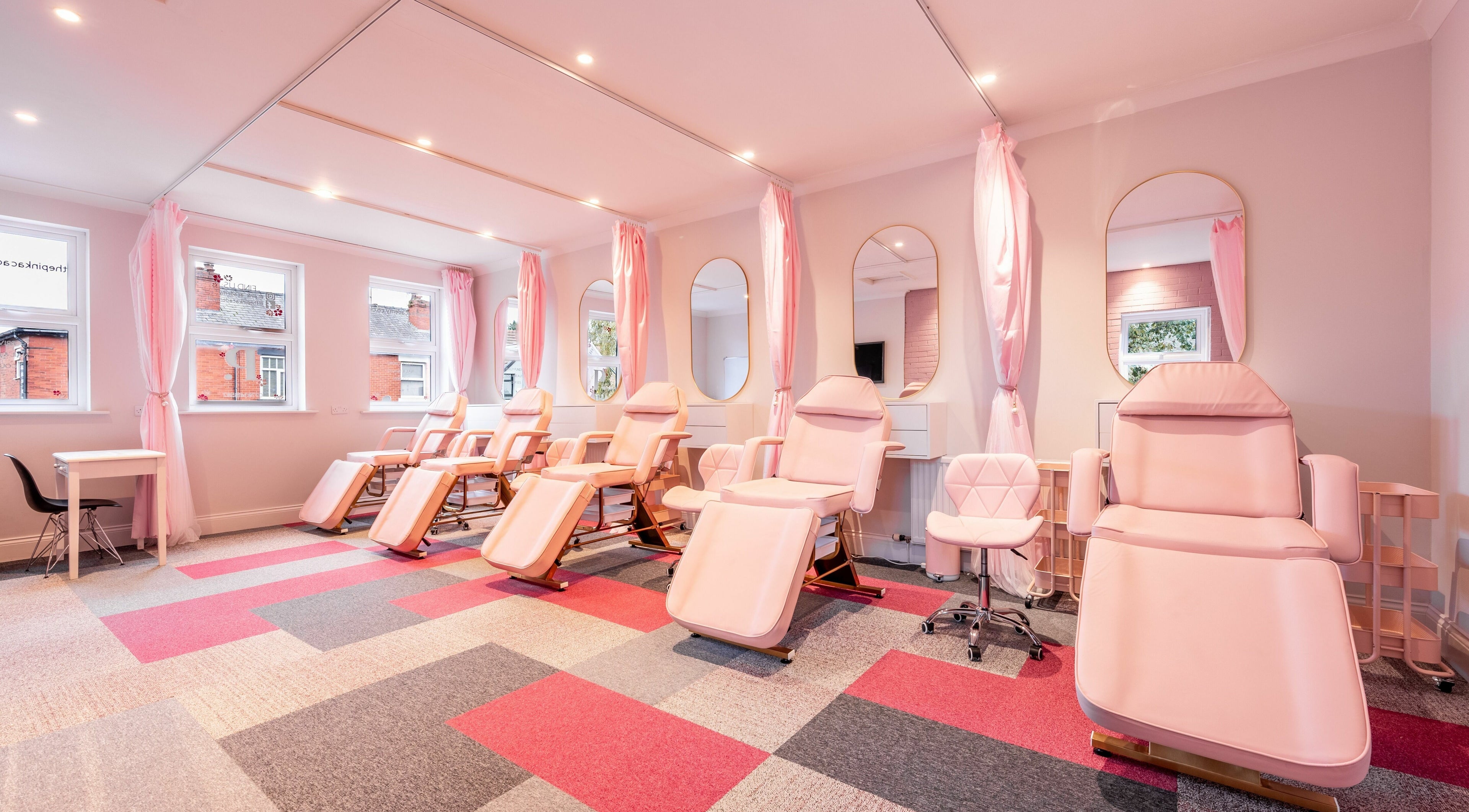 Elegant massage chairs and mirrors at Pink. Academy, Worsley, England, GB offer a serene beauty experience.