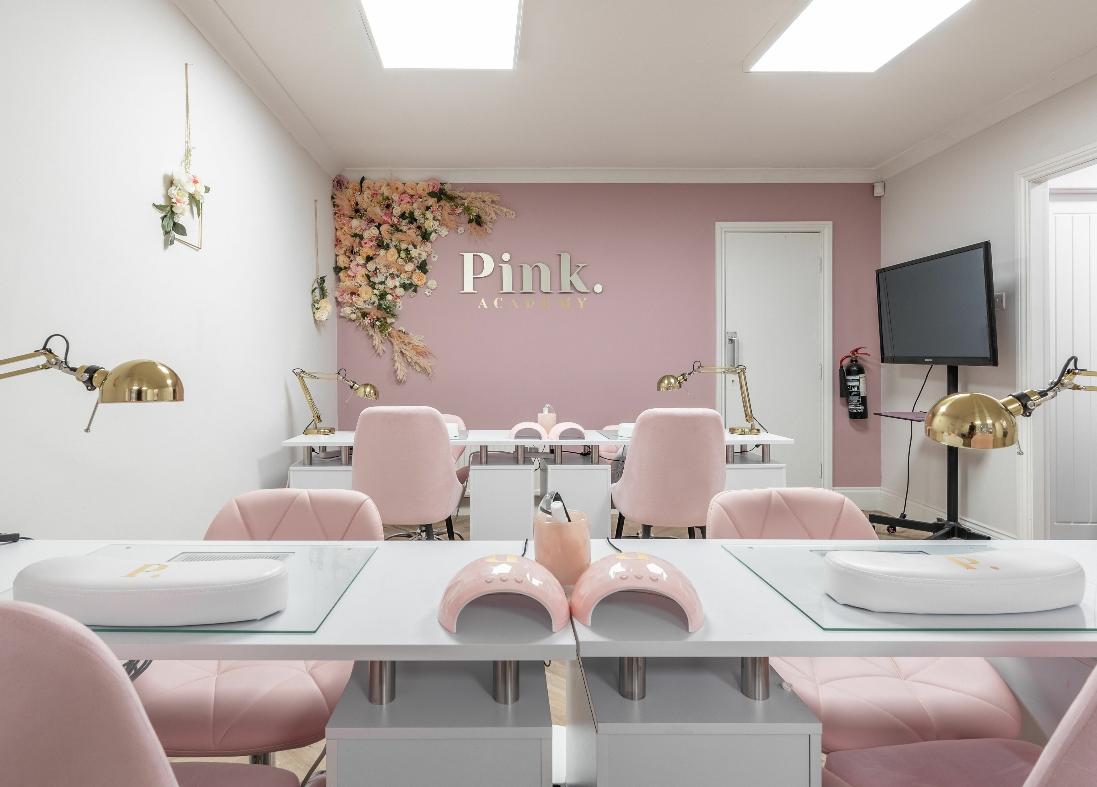 Sophisticated nail studio at Pink. Academy, Worsley, England, GB, featuring pink decor and modern manicure stations.