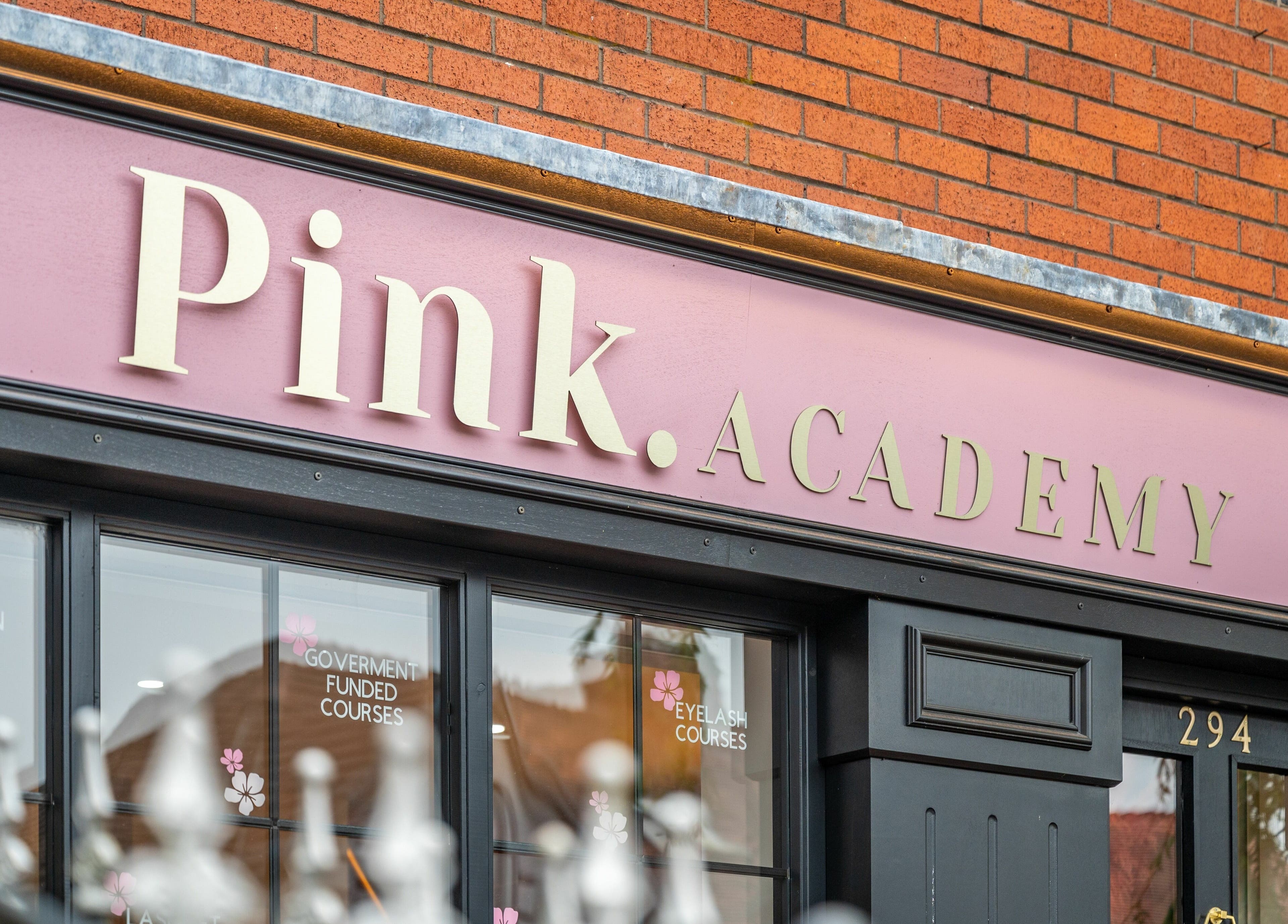 Front view of Pink. Academy's sign and entrance in Worsley, England, GB.
