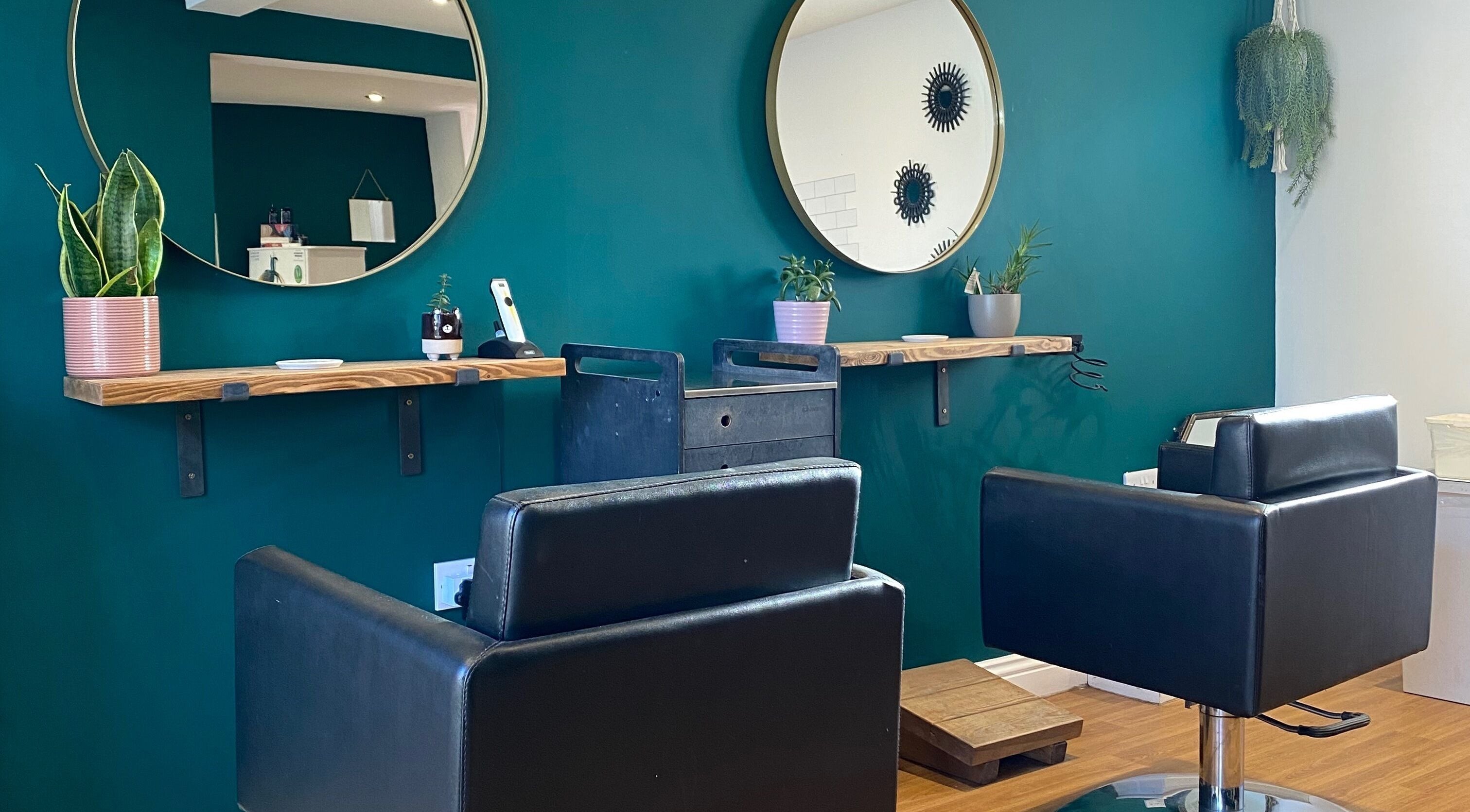 Modern salon interior at Fringe, Bolsover, England, GB with chic decor and sleek styling chairs.