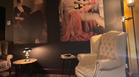 Cozy lounge at Nelson Brown with art decor, Dumfries, Scotland, GB, featuring armchairs and ambient lighting.