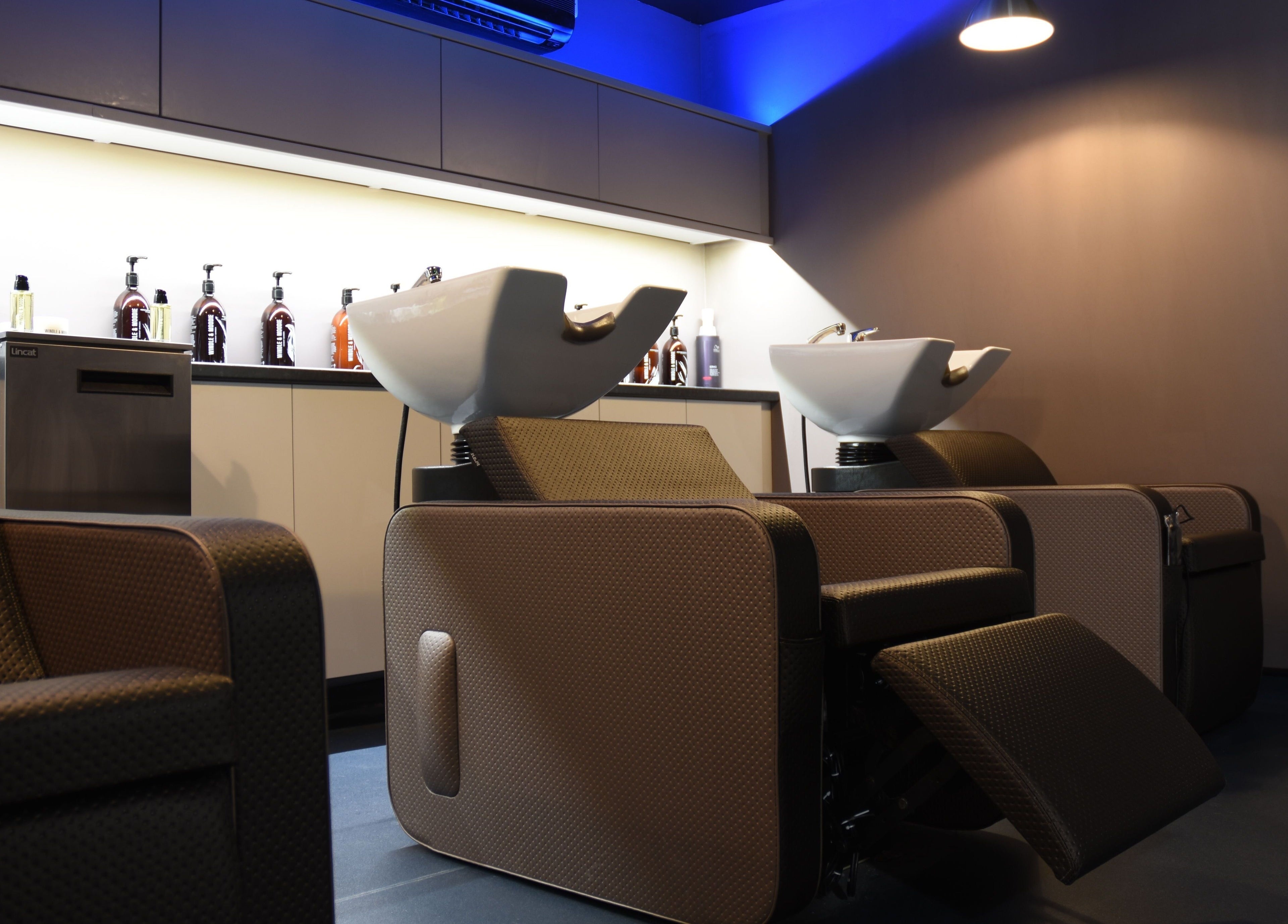 Modern salon interior at Nelson Brown in Dumfries, Scotland, GB, featuring luxury wash stations.