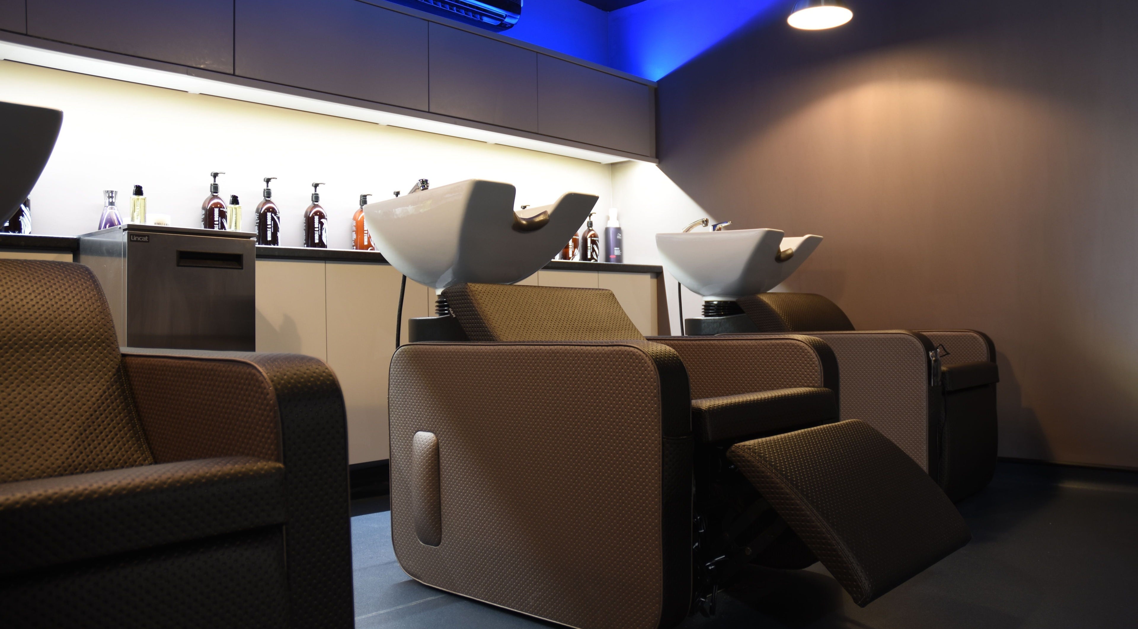 Modern salon interior at Nelson Brown in Dumfries, Scotland, GB, featuring luxury wash stations.
