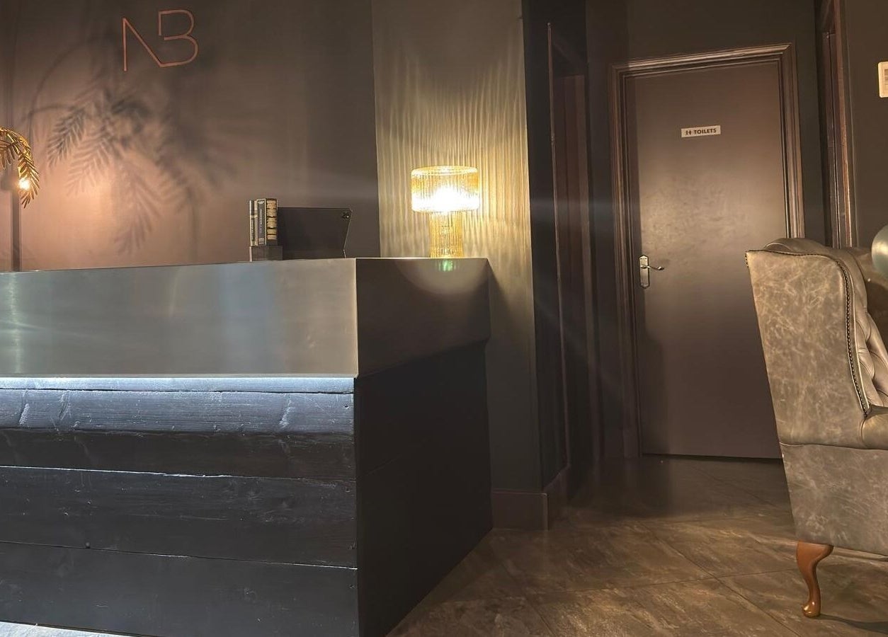 Elegant reception area at Nelson Brown, Dumfries, Scotland, GB with modern decor and ambient lighting.