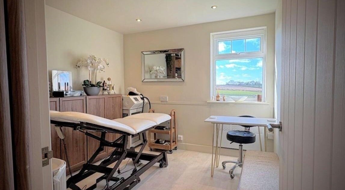 Bright treatment room at Proper Beauty Chicheley, Newport Pagnell, England, with a view of the countryside.