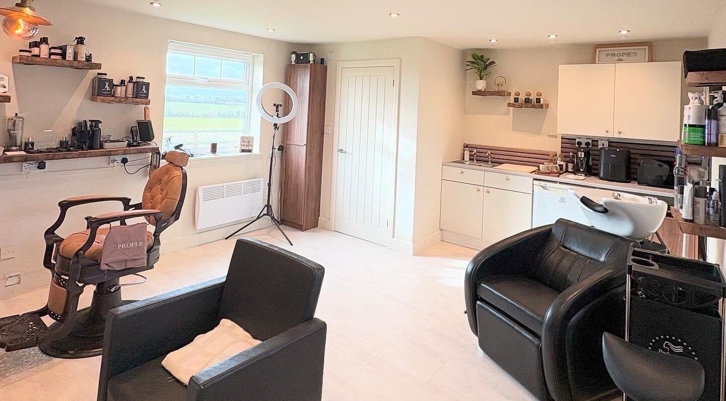 Modern salon interior at Proper Beauty Chicheley in Newport Pagnell, England, GB with stylish chairs and equipment.