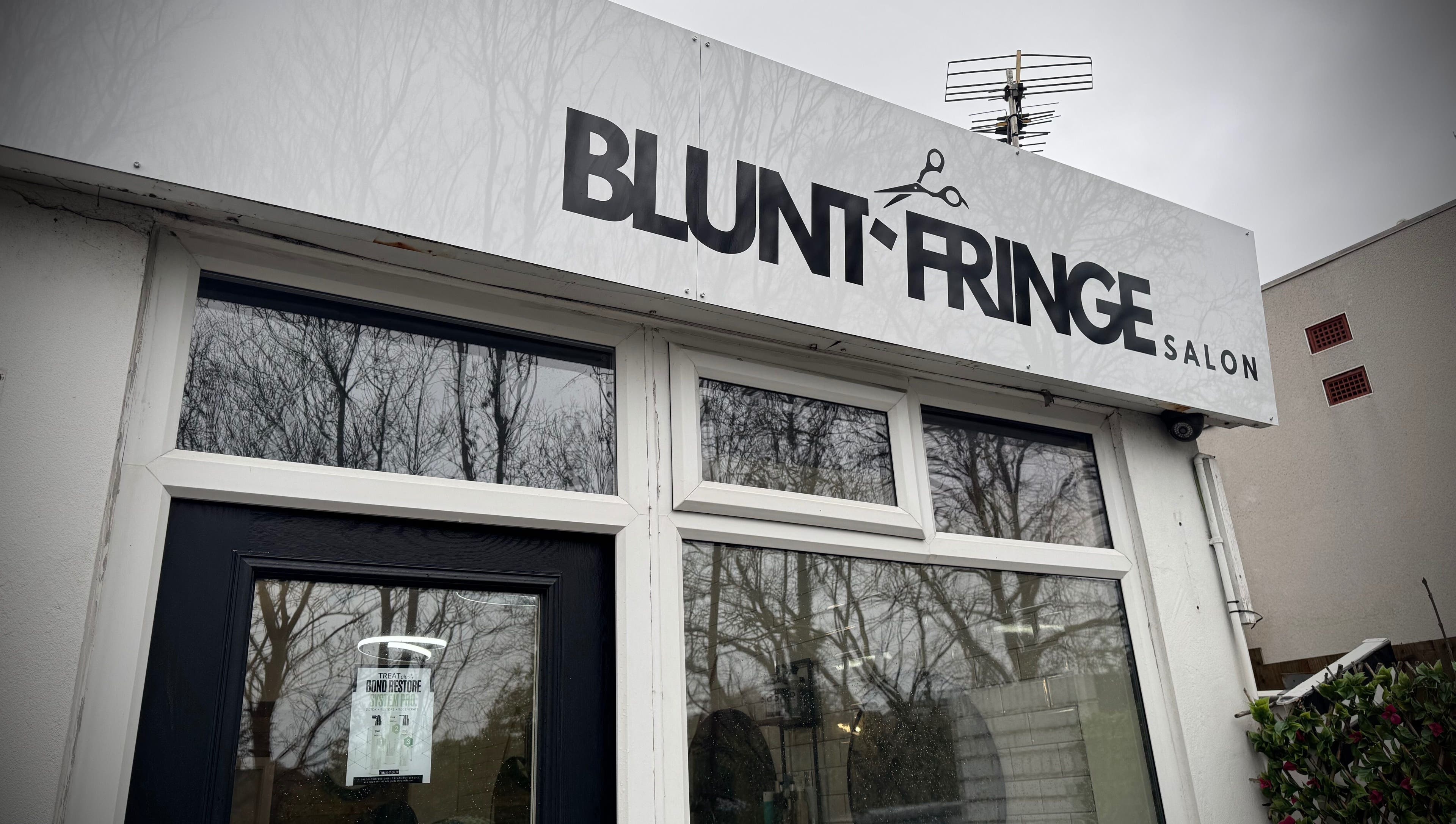 Front view of Christopher at BLUNT FRINGE Salon in Rowley Regis, England, GB, featuring modern signage.