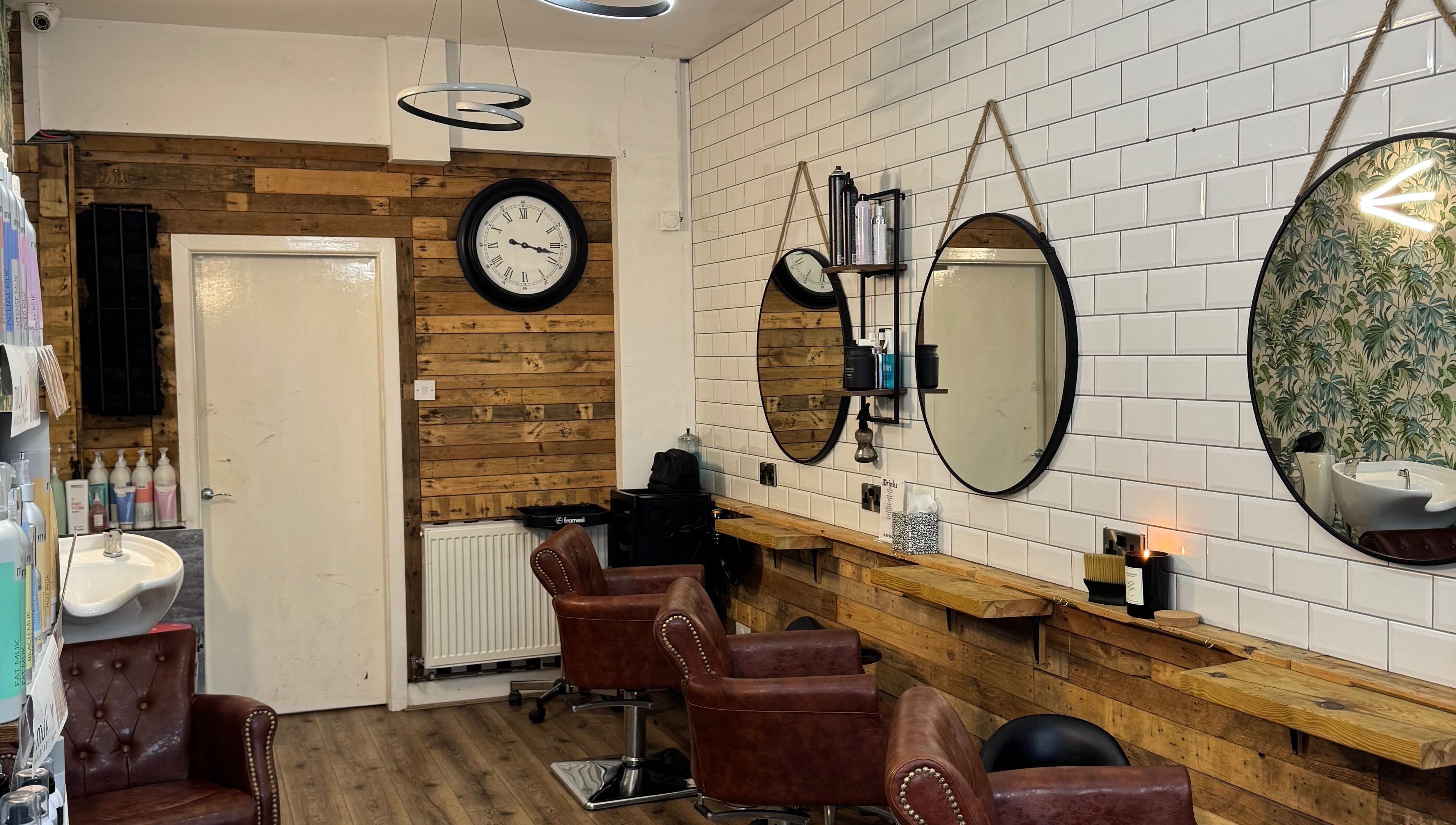 Modern interior of Christopher at BLUNT FRINGE Salon in Rowley Regis, England, GB with rustic decor.