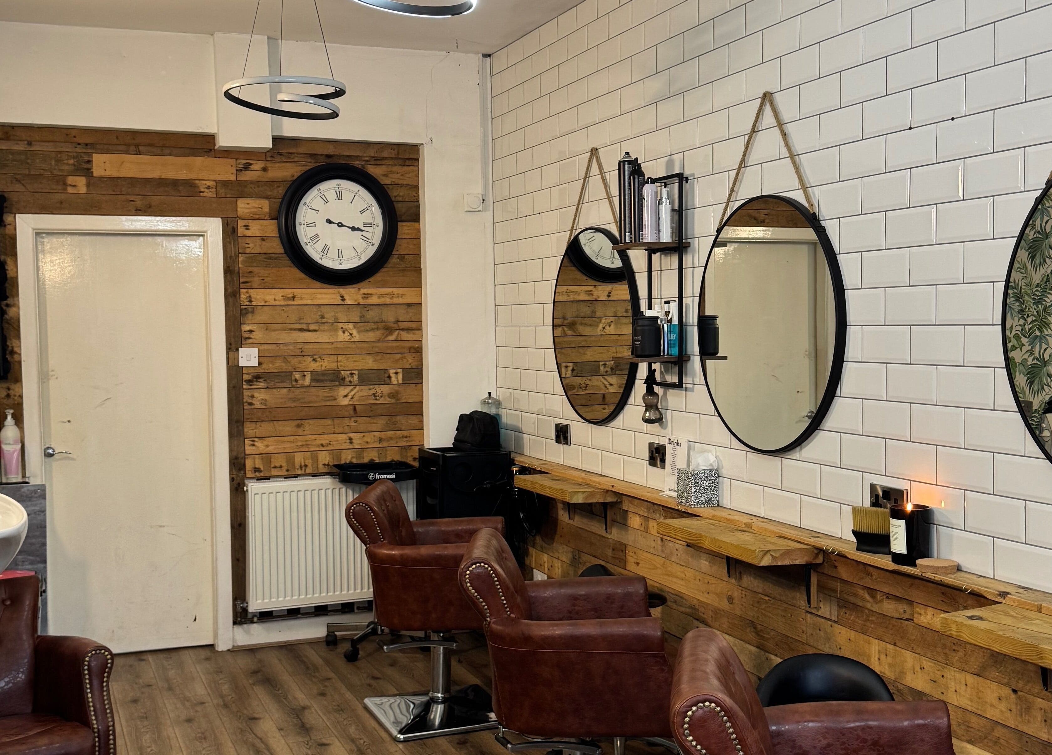 Modern interior of Christopher at BLUNT FRINGE Salon in Rowley Regis, England, GB with rustic decor.