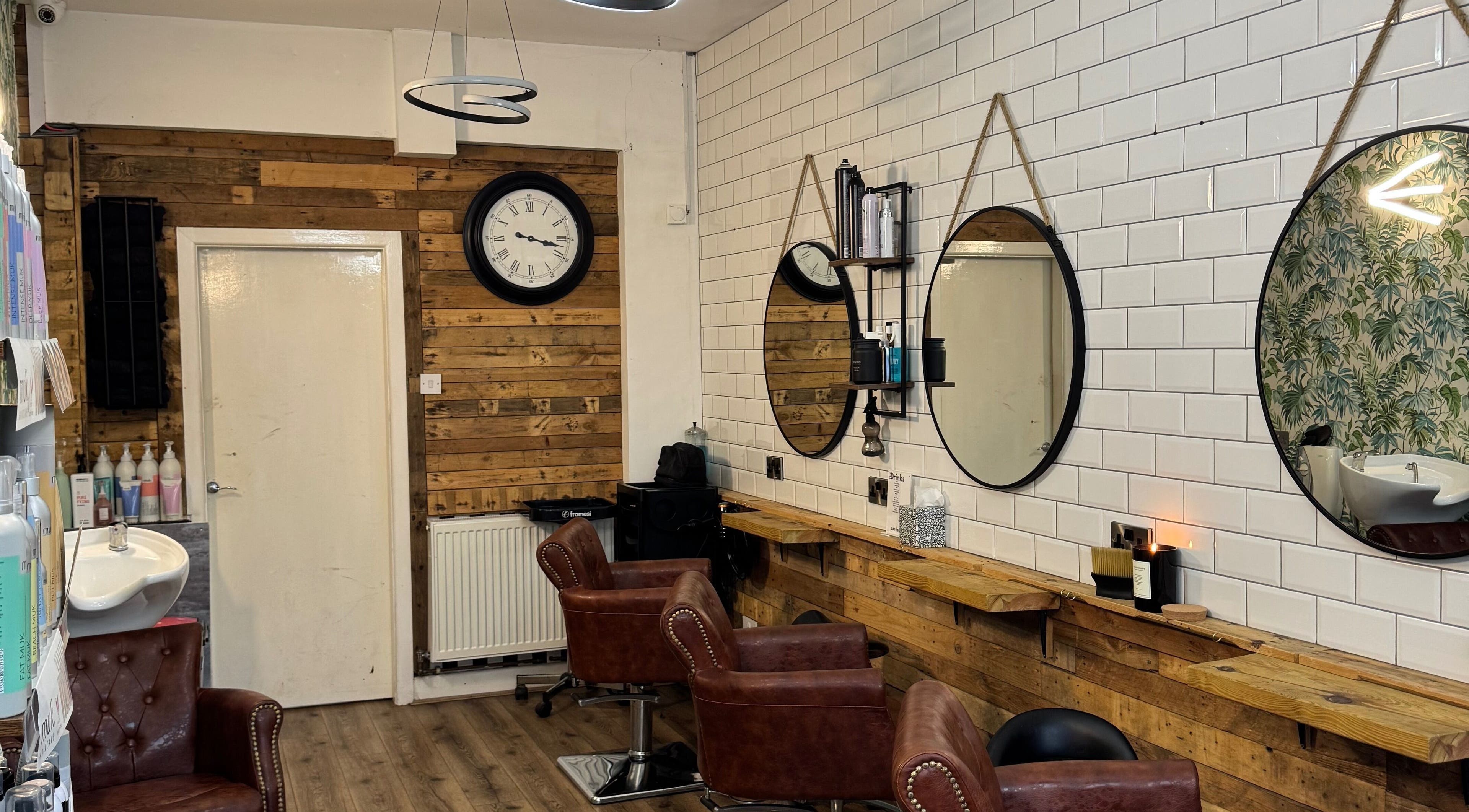 Modern interior of Christopher at BLUNT FRINGE Salon in Rowley Regis, England, GB with rustic decor.