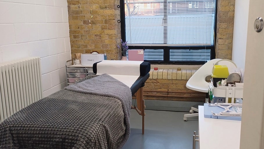 A cozy treatment room at Rachel’s Beauty Treatments in London, England, GB, featuring a comfortable massage bed.