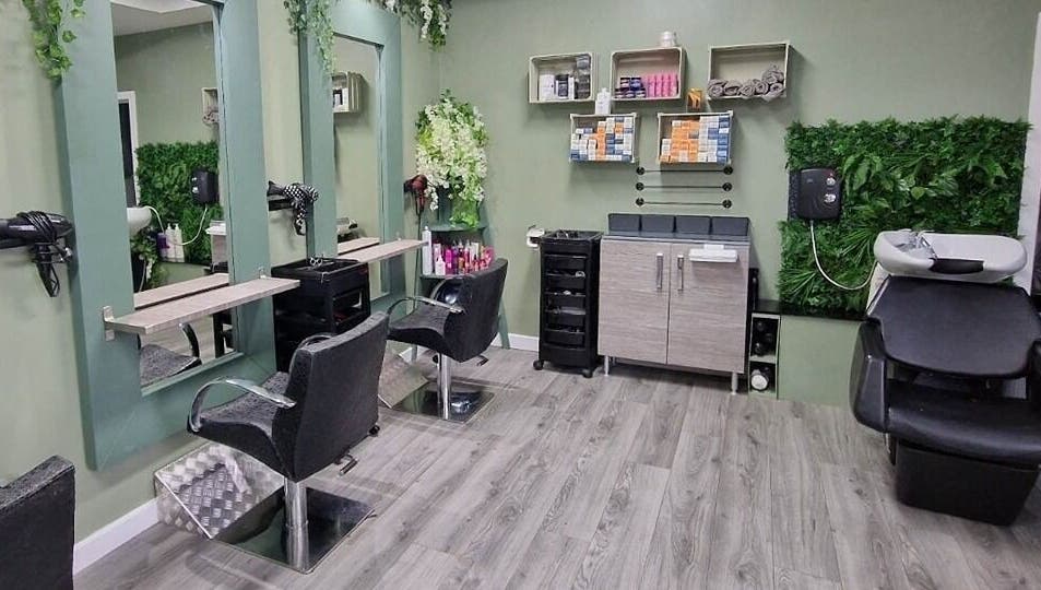 Modern salon seating at Avenue One in Dunfermline, Scotland, GB with stylish decor and greenery.