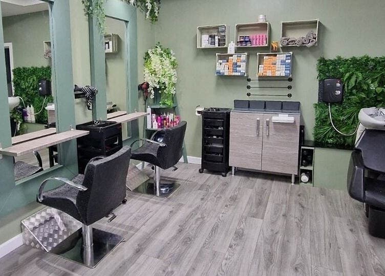 Modern salon seating at Avenue One in Dunfermline, Scotland, GB with stylish decor and greenery.