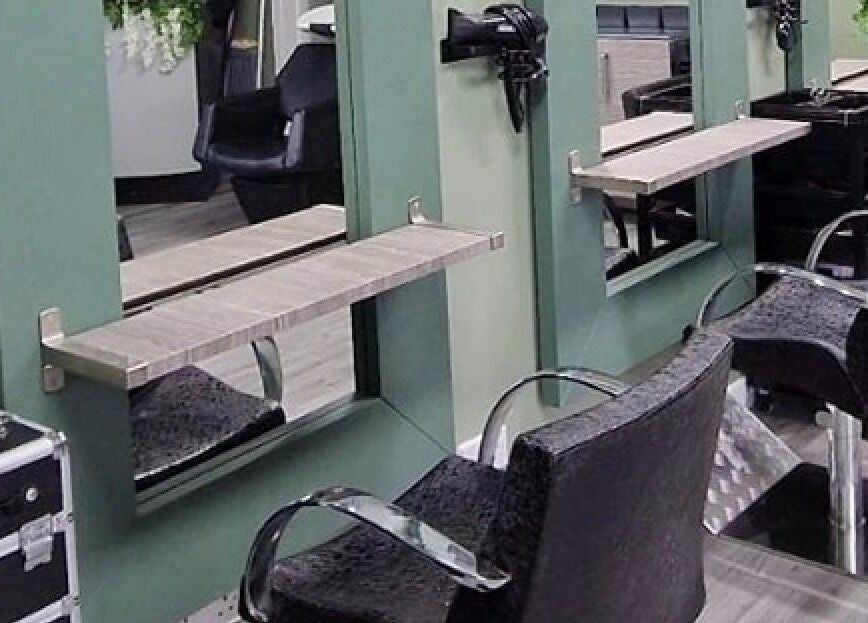 Modern salon chairs and mirrors at Avenue One, Dunfermline, Scotland, GB. Elegant hair styling area.