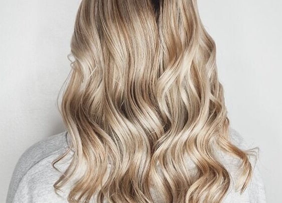 Blonde wavy hair styled at Avenue One, Dunfermline, Scotland, GB showcasing elegant beauty services.