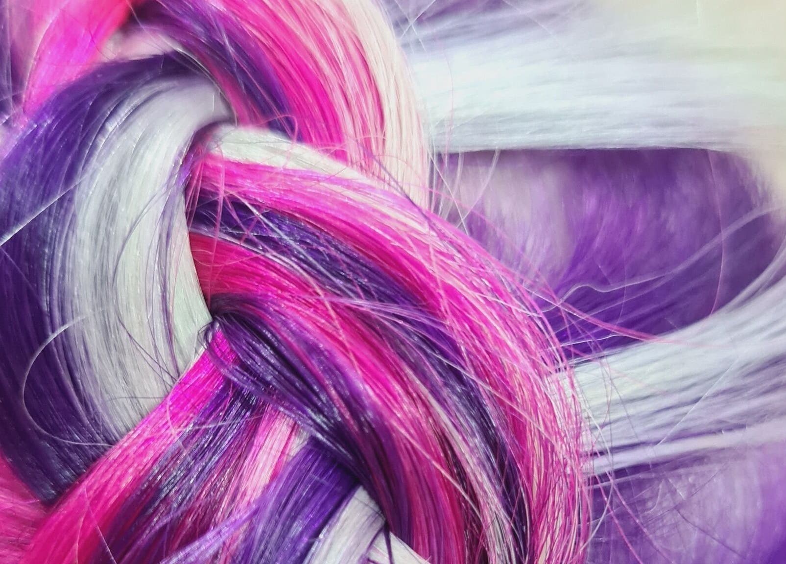 Close-up of vibrant pink and purple braided hair at Avenue One, Dunfermline, Scotland, GB.