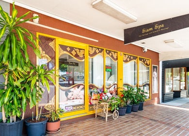 Entrance of Siam Spa - Therapeutic Massage & Wellness Morningside, Queensland, AU, with lush plants and signage.