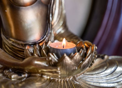 A calming candle in a bronze statue at Siam Spa 159 - Therapeutic Massage & Wellness, Morningside, Queensland, AU.