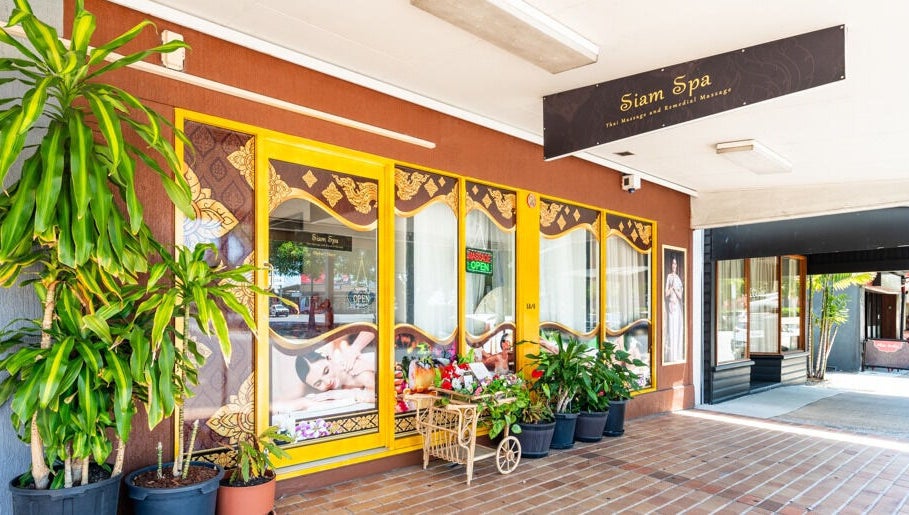 Entrance of Siam Spa - Therapeutic Massage & Wellness Morningside, featuring elegant decor and vibrant plants, Morningside, Queensland, AU.