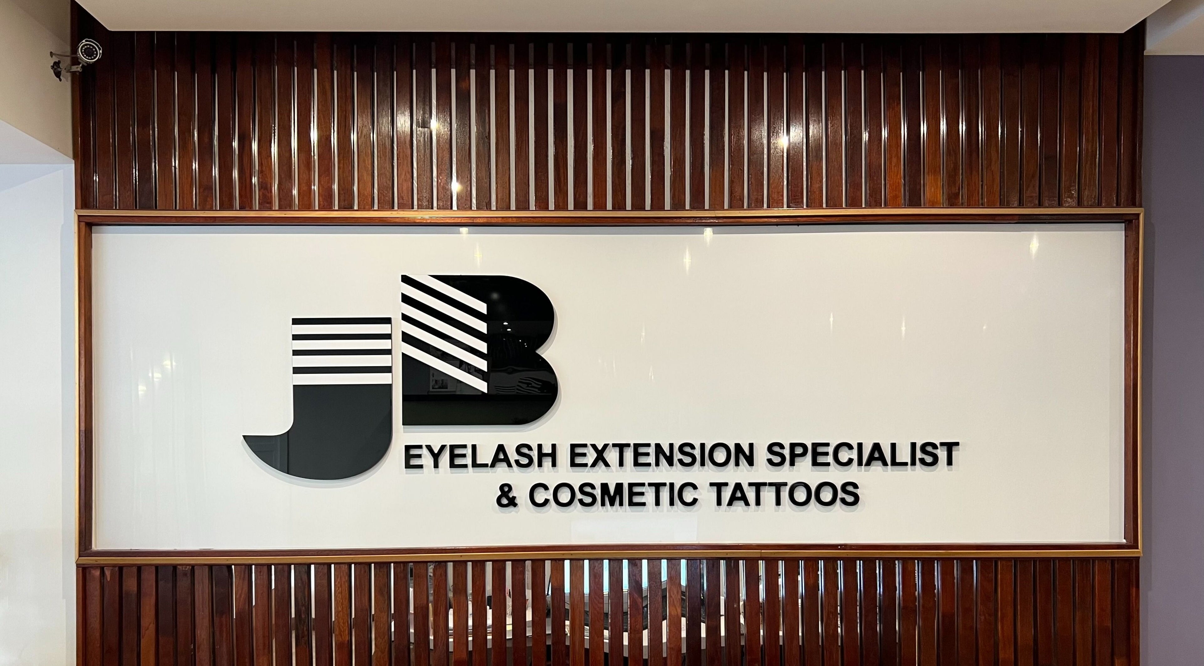 Entrance sign for J-Beauty South Melbourne Store in Melbourne, Victoria, AU, showcasing eyelash extension and tattoo services.
