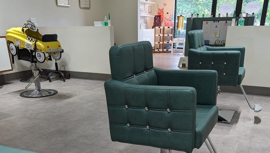 Interior of Sage Kids Family Salon & Piercing Boutique in West Linn, Oregon, US with chic salon chairs.
