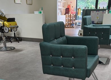 Interior of Sage Kids Family Salon & Piercing Boutique in West Linn, Oregon, US with chic salon chairs.