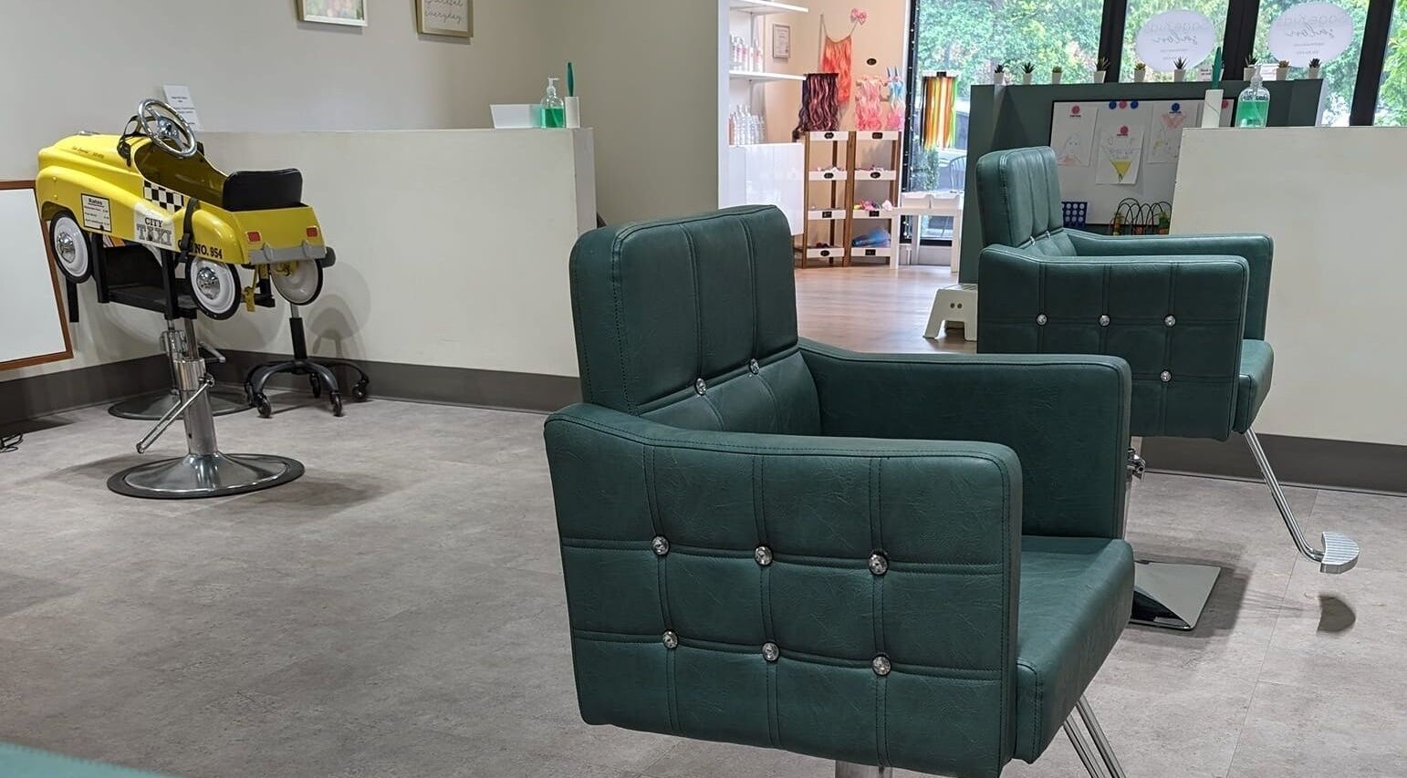Interior of Sage Kids Family Salon & Piercing Boutique in West Linn, Oregon, US with chic salon chairs.