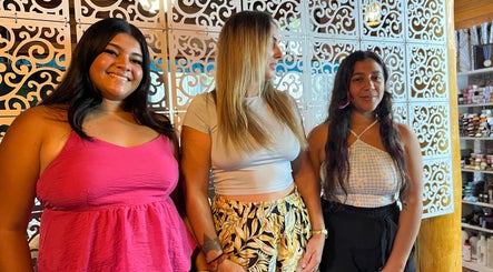 Three women smiling at CG Bella Extensions, St Thelmo by Abrazos hotel, San Pedro, BZ.