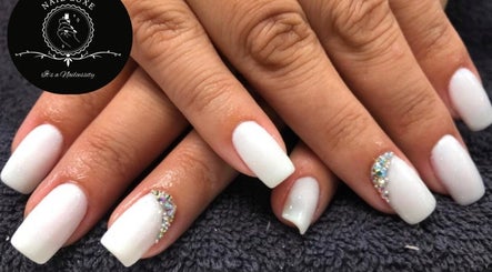 Elegant white manicured nails with crystals at Nail Luxe, Davie, Florida, US.