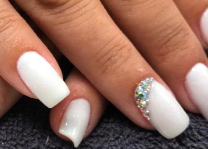Elegant white nails with rhinestones at Nail Luxe, Davie, Florida, US showcasing stylish manicure.