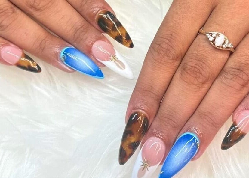 Stylish nail art design at Nail Luxe, Davie, Florida, US. Features mixed color patterns on acrylic nails.