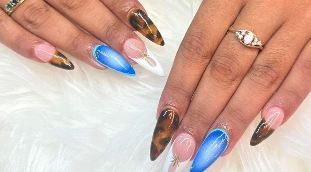 Stylish nail art design at Nail Luxe, Davie, Florida, US. Features mixed color patterns on acrylic nails.
