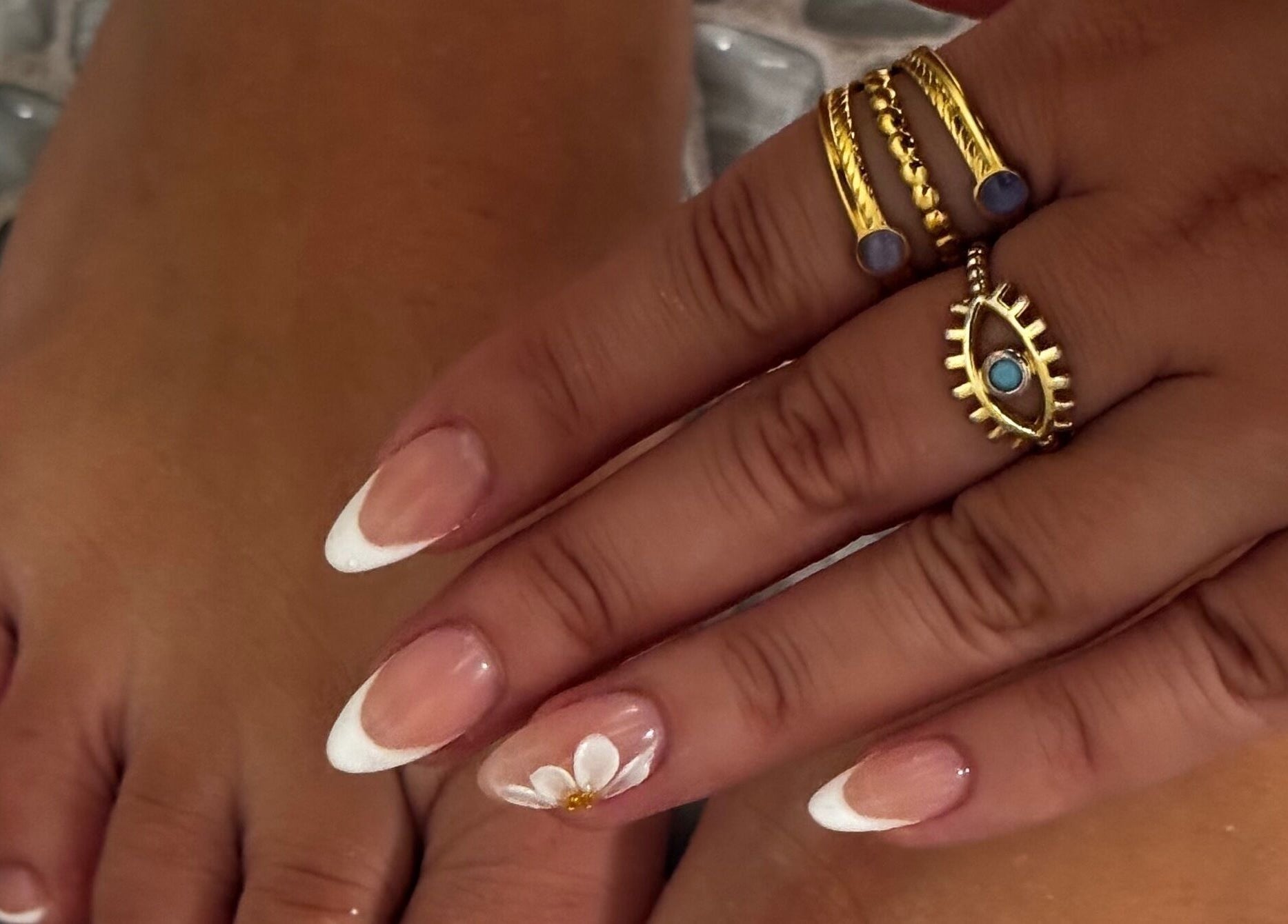 Chic French manicure with floral design at Nail Luxe, Davie, Florida, US.