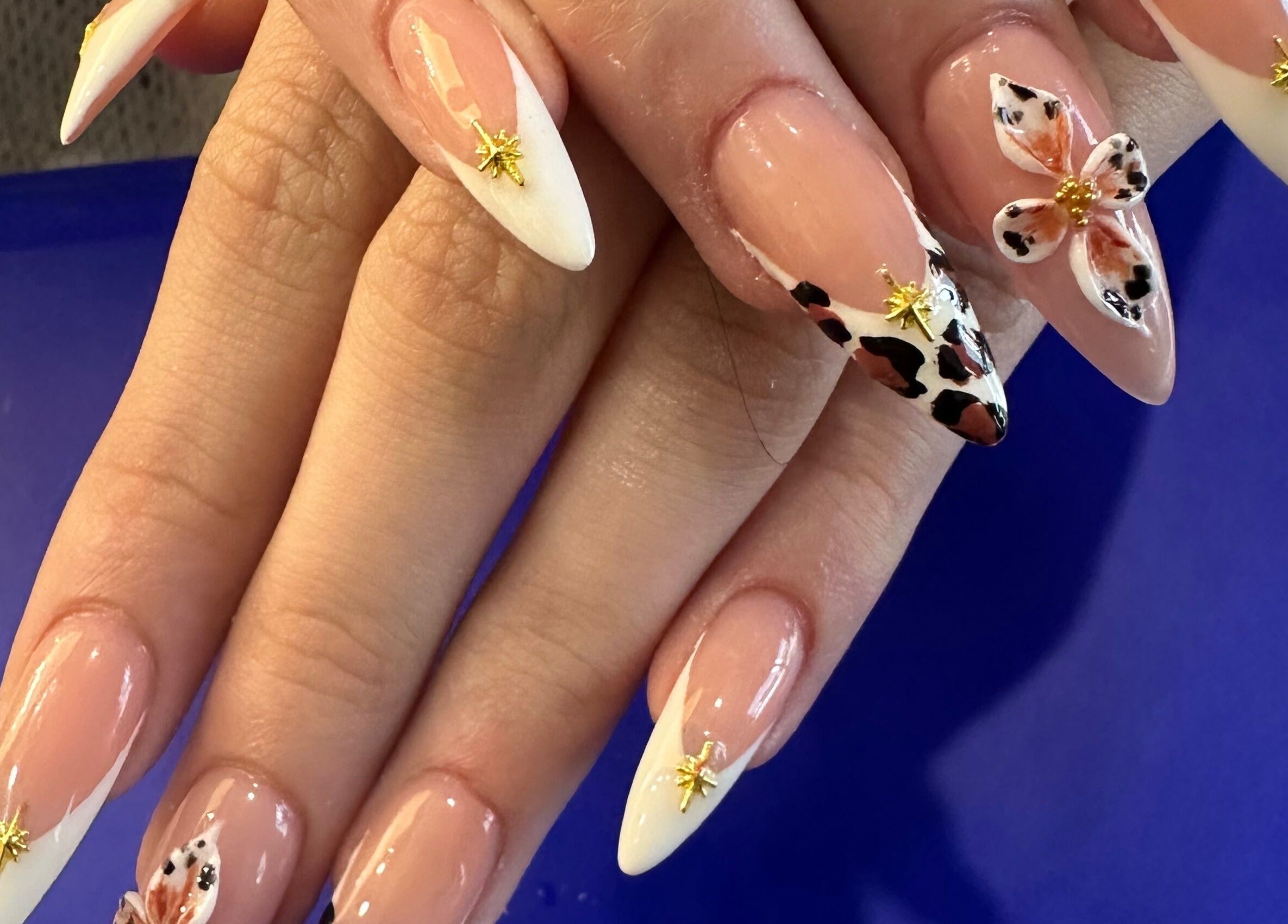 Elegant nail art with floral and leopard prints at Nail Luxe, Davie, Florida, US.