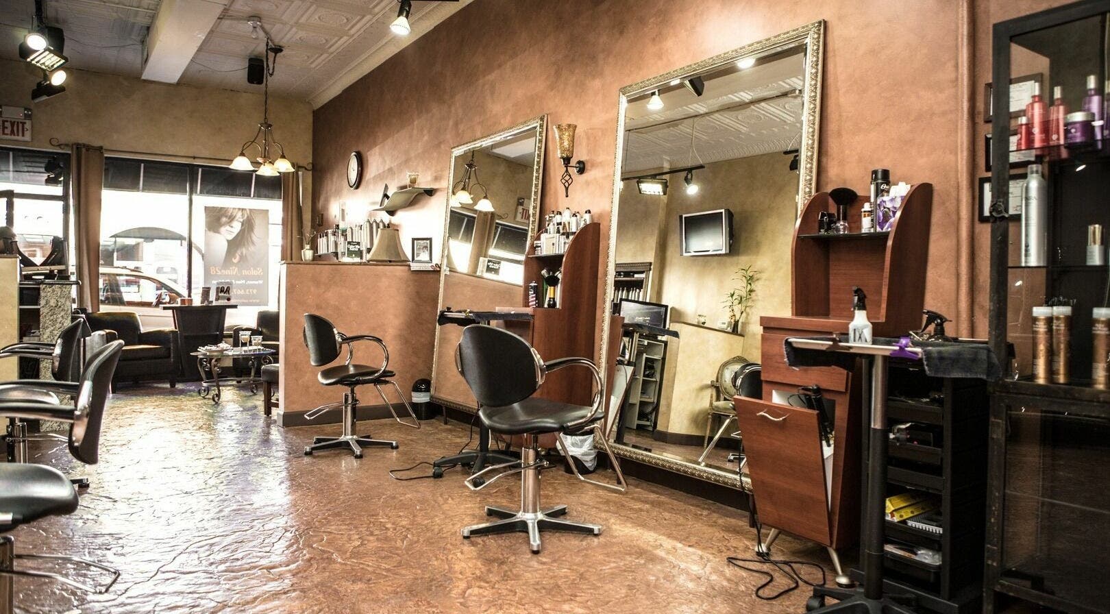 Elegant interior of Salon Nine28 in Nutley, New Jersey, US, showcasing styling chairs and mirrors.