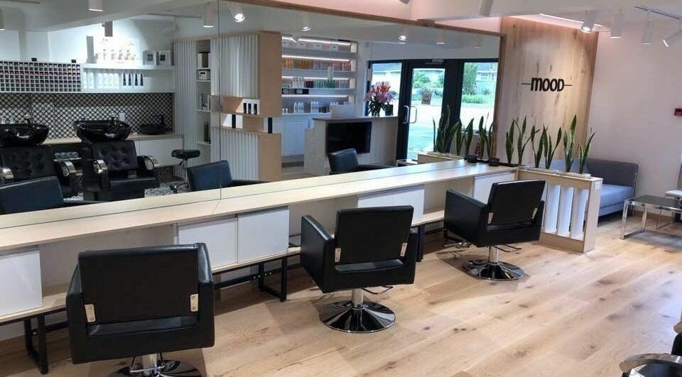 Interior of Mood Hair Salon in Christchurch, Canterbury, NZ featuring elegant styling chairs and a serene atmosphere.