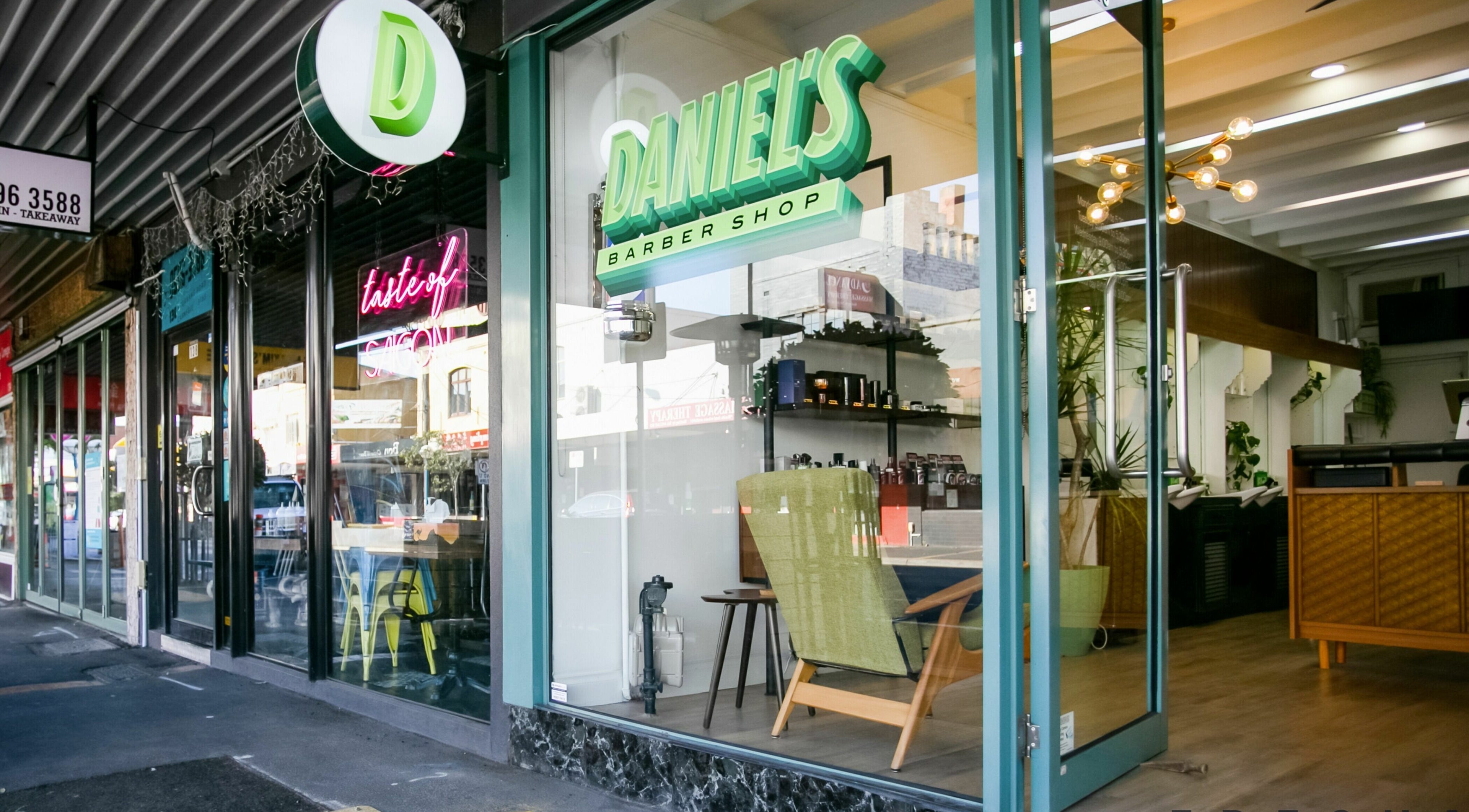 Front view of Daniel’s Barbershop in Melbourne, Victoria, AU, showcasing stylish interior and welcoming entrance.