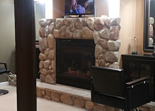 Cozy interior of Halo Salon And Medi Spa in Scranton, Pennsylvania, US, featuring stone fireplace and salon chair.